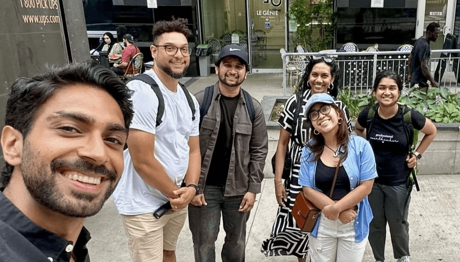 A DesignWalks group on a Toronto sidewalk on a summer walk, smiling toward the camera