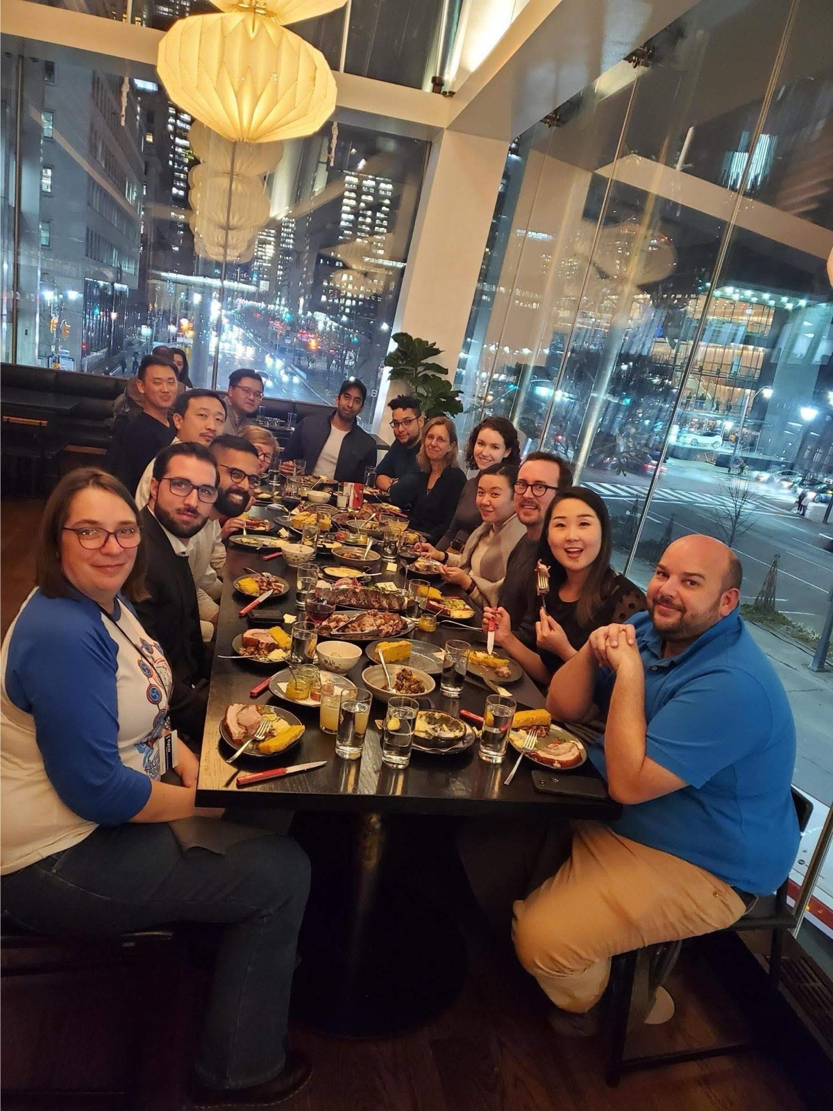 A team dinner with the Toronto skyline behind the table